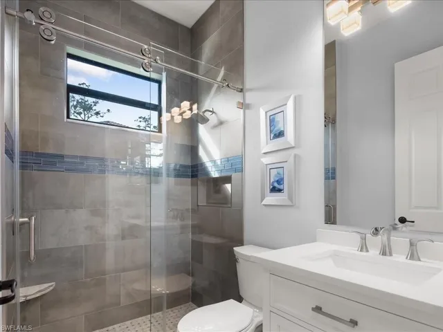 Bathroom featuring vanity and a stall shower