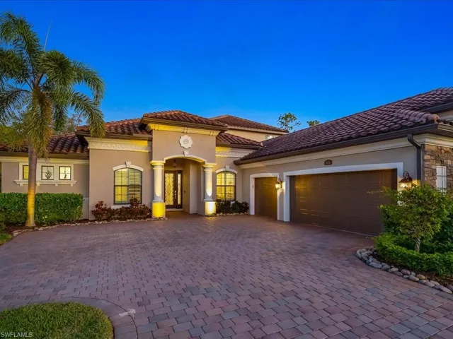 Mediterranean / spanish house with stucco siding, decorative driveway, a tiled roof, an attached garage, and stone siding