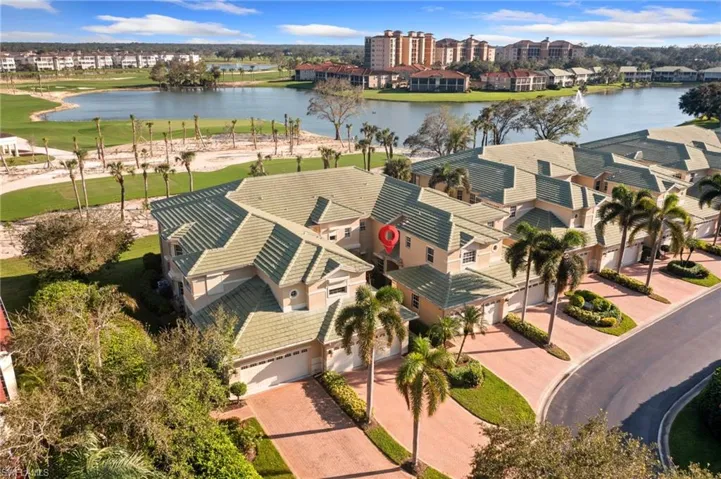 Birds eye view of property with a water and golf course view