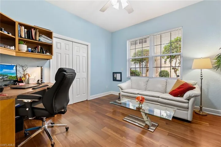Office space with hardwood / wood-style flooring and ceiling fan