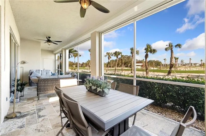 Screened patio featuring ceiling fan and golf course view