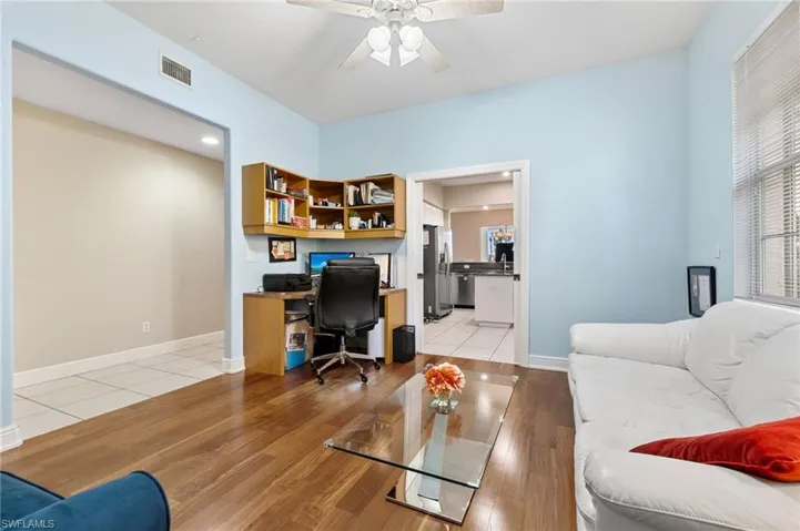 Home office with ceiling fan and light hardwood / wood-style floors