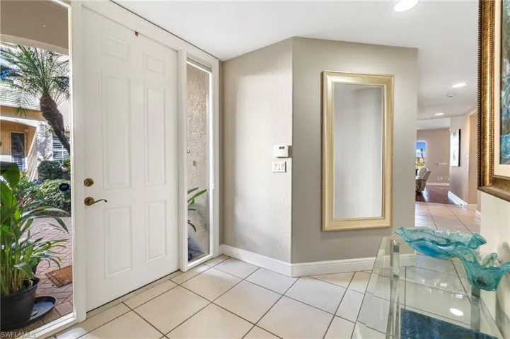 Entrance foyer with light tile patterned floors