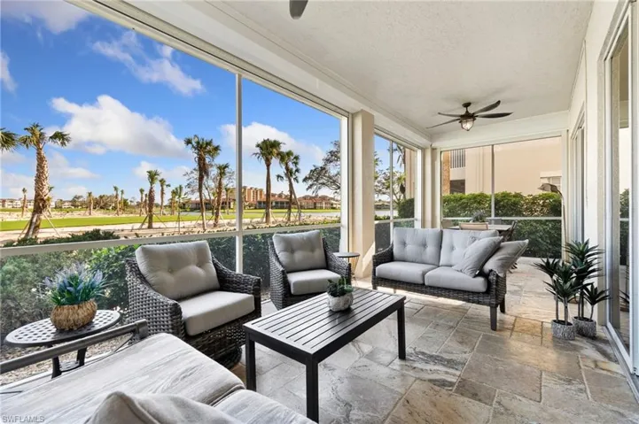 Screened patio with ceiling fan and golf course view