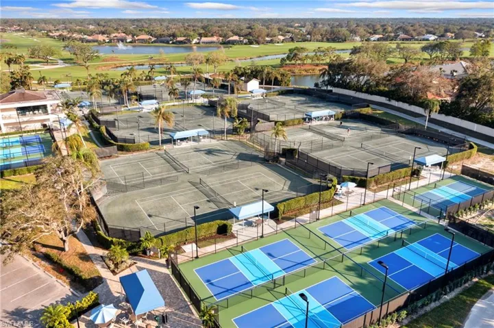 Birds eye view of property with a water view as well view to tennis and pickleball courts