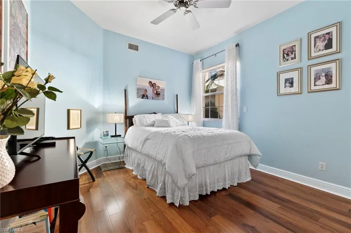 Bedroom with ceiling fan and wood-type flooring