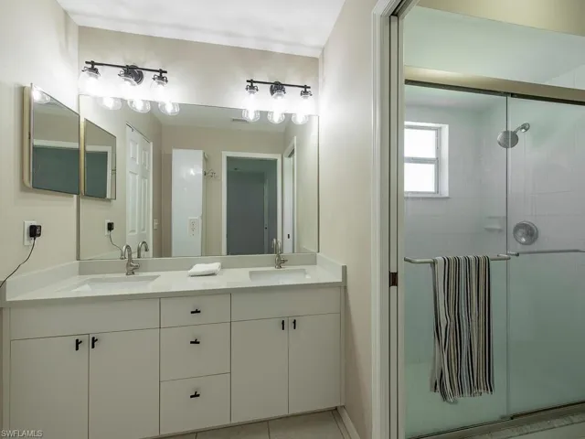 Primary bathroom with double sinks and walk in shower
