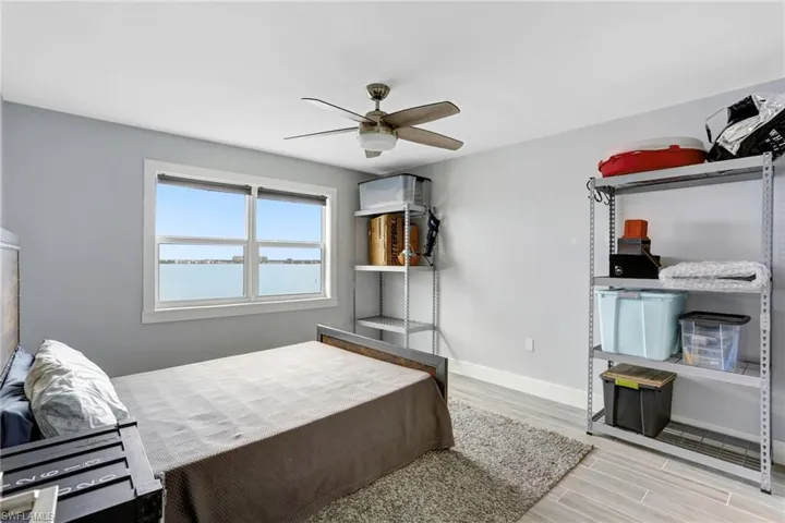 Bedroom with ceiling fan and light hardwood / wood-style flooring