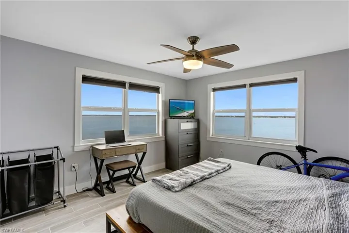 Bedroom with light hardwood / wood-style floors and ceiling fan