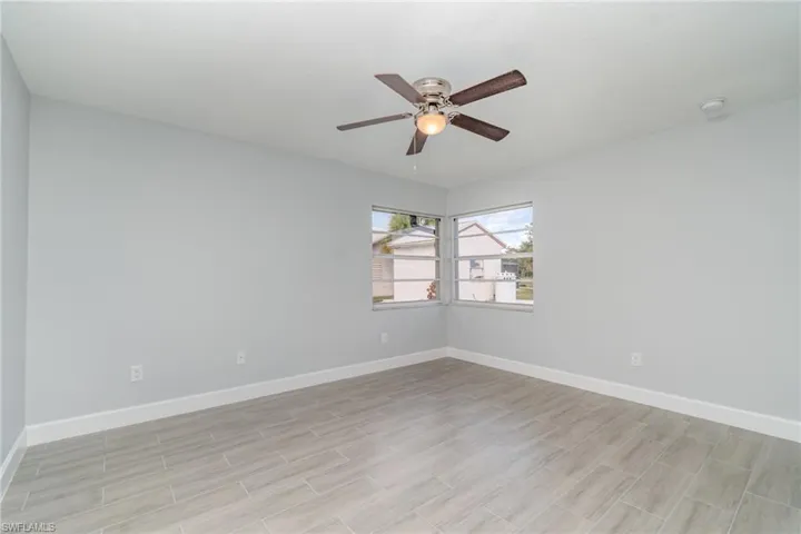 Spare room featuring wood finish floors and ceiling fan