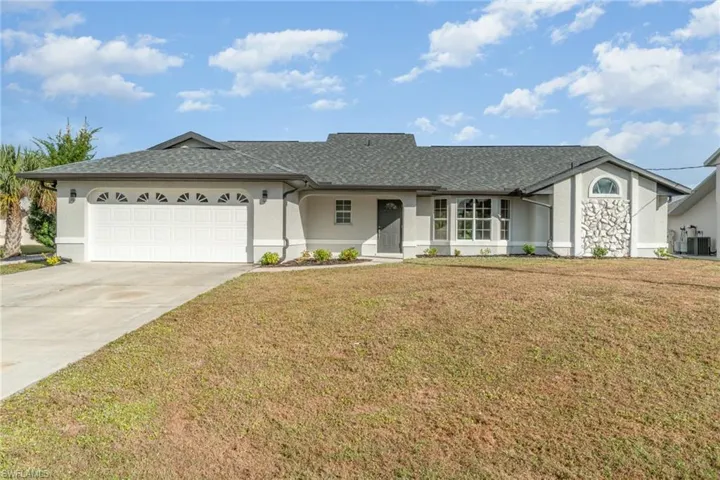 Ranch-style house featuring stucco siding, an attached garage, concrete driveway, roof with shingles, and a front lawn