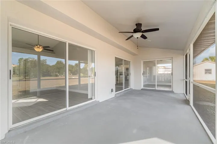 Unfurnished sunroom featuring ceiling fan and lofted ceiling