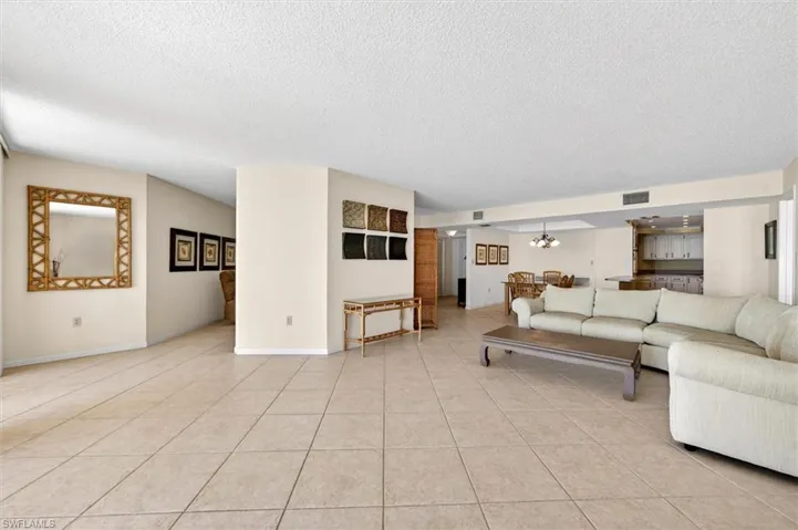 Spacious living area featuring large format tile flooring and a neutral color palette