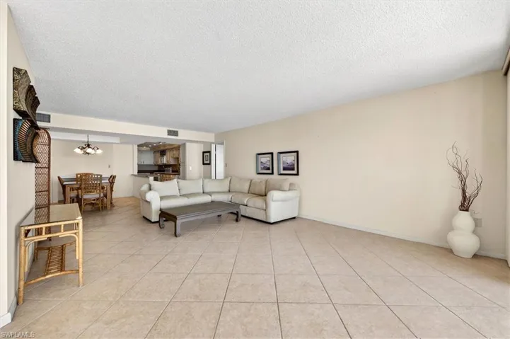 Spacious living area featuring large format tile flooring, neutral wall tones, and recessed lighting