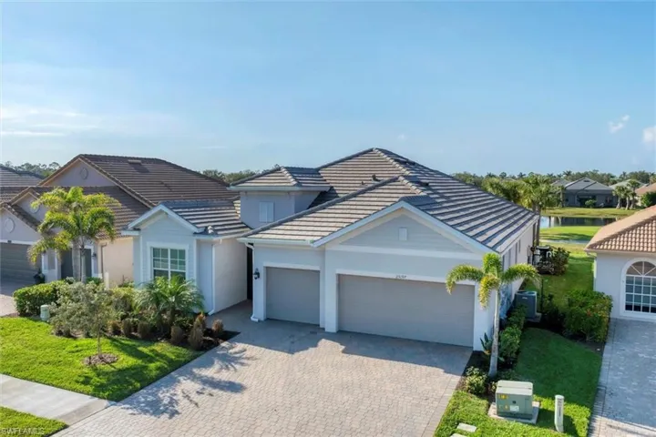 View of front of house featuring a garage and a front lawn