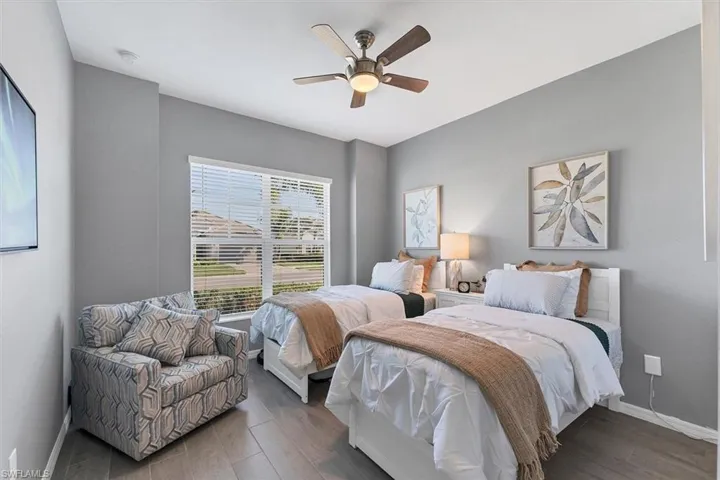 Bedroom with ceiling fan and dark hardwood / wood-style floors