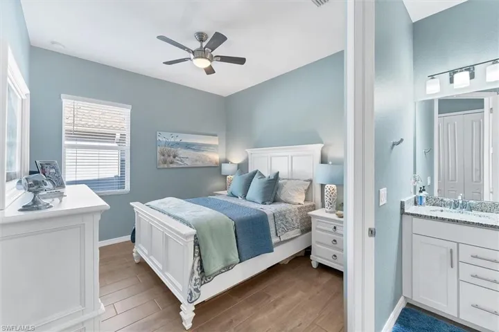 Bedroom featuring sink, light hardwood / wood-style flooring, and ceiling fan