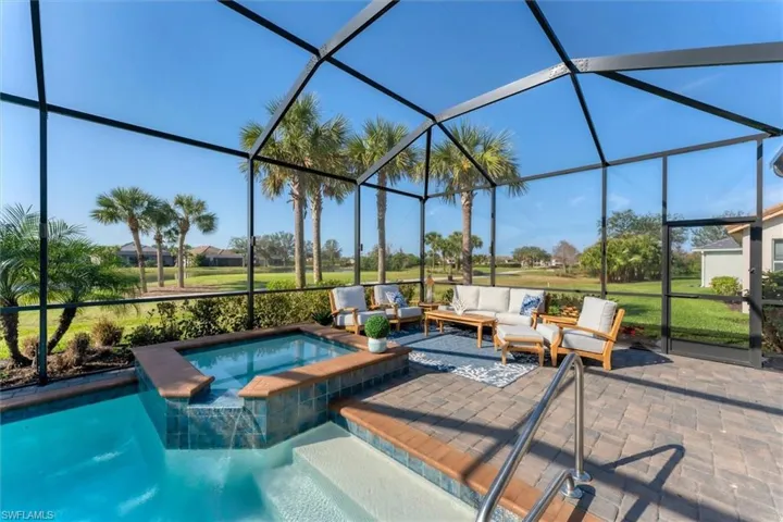 View of pool with an outdoor living space, a lanai, a patio area, and an in ground hot tub
