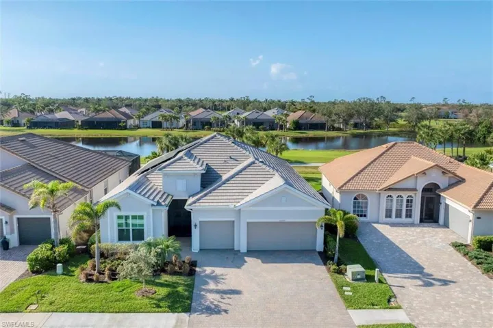 View of front of home featuring a water view and a garage