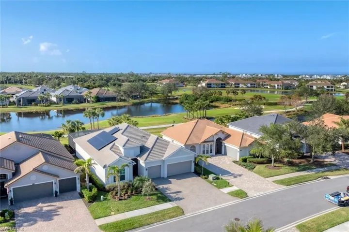Birds eye view of property with a water view