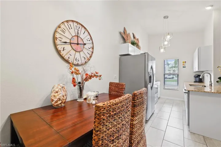 Dining area with light tile patterned flooring and sink