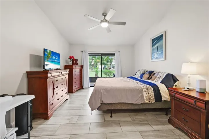 Bedroom featuring lofted ceiling, access to outside, and ceiling fan