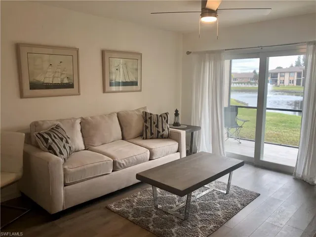 Living area with light-toned wood-finish flooring