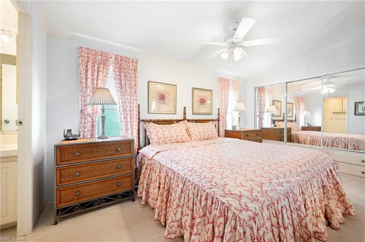 Bedroom featuring lofted ceiling, a closet, crown molding, and carpet floors