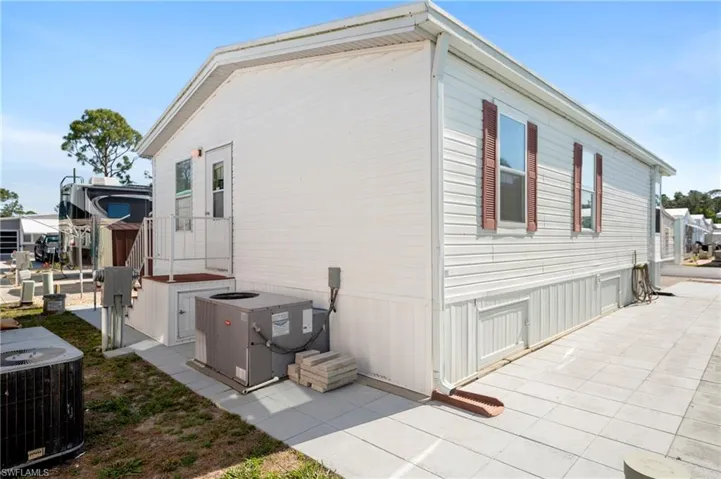 View of property exterior with cooling unit and a patio