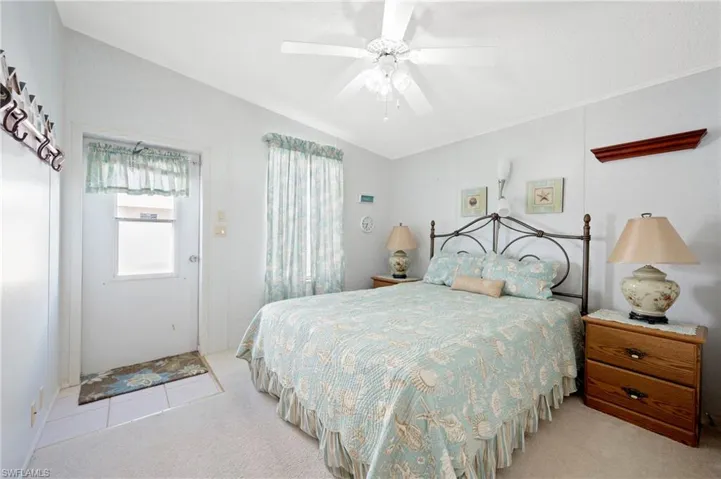 Bedroom featuring ornamental molding, a ceiling fan, and carpet floors