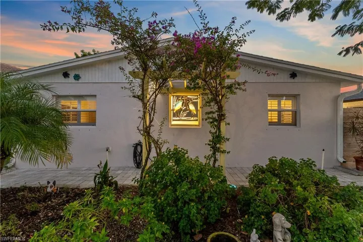 Property exterior at dusk with a patio area and stucco siding