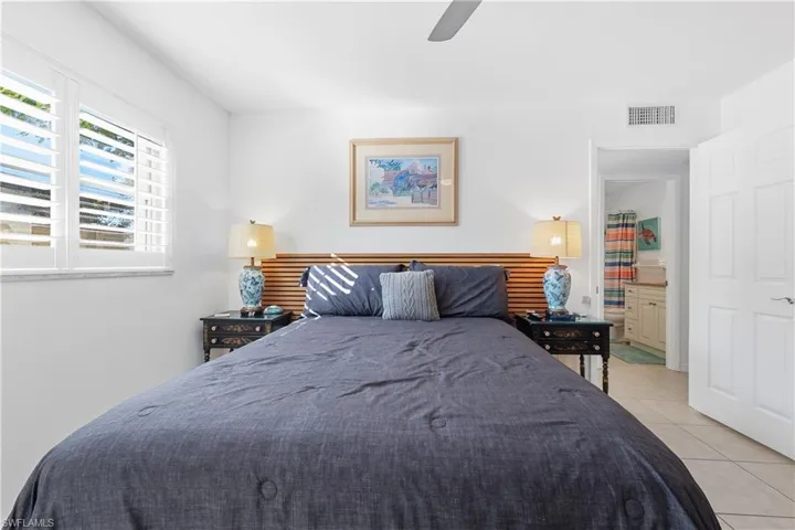 Bedroom featuring light tile patterned floors and ceiling fan