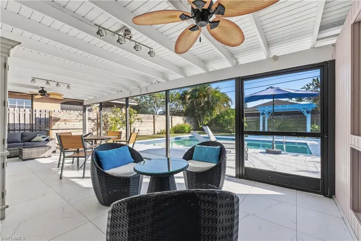 Fenced backyard featuring ceiling fan, outdoor dining space, a patio, and an outdoor living space
