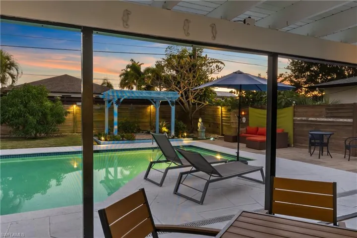 Pool at dusk with a pergola, a patio area, an outdoor pool, and an outdoor living space