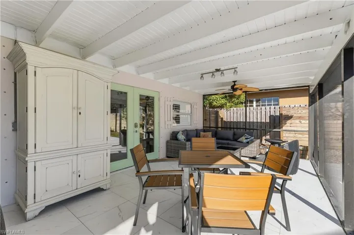 Sunroom with a patio, french doors, outdoor lounge area, ceiling fan, and beamed ceiling