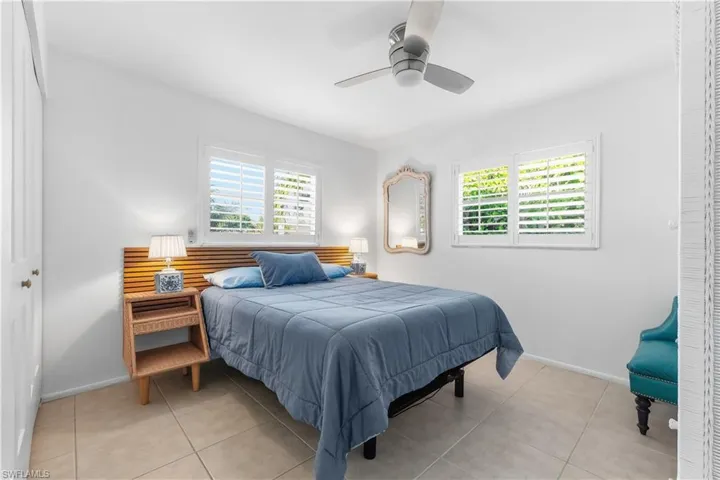 Tiled bedroom featuring a closet and a ceiling fan