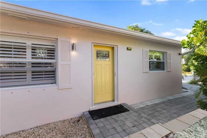 View of exterior entry featuring stucco siding and a patio