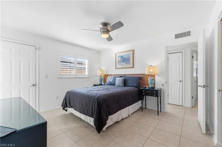 Bedroom featuring light tile patterned floors and a ceiling fan