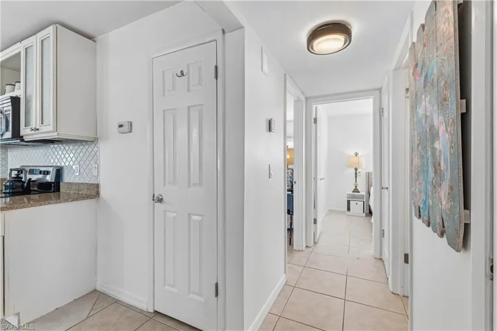 Hallway featuring light tile patterned floors