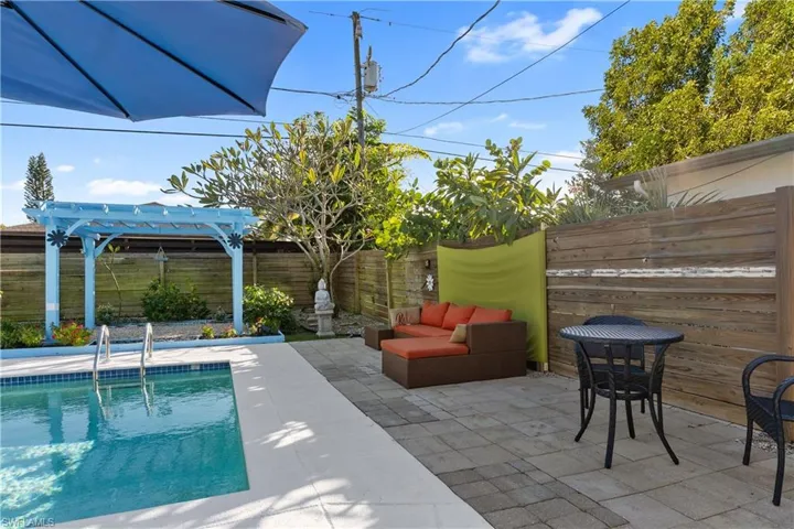 Fenced backyard featuring a patio, a pergola, and outdoor lounge area