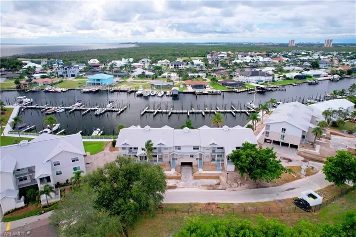 Aerial view of residential area featuring a nearby body of water