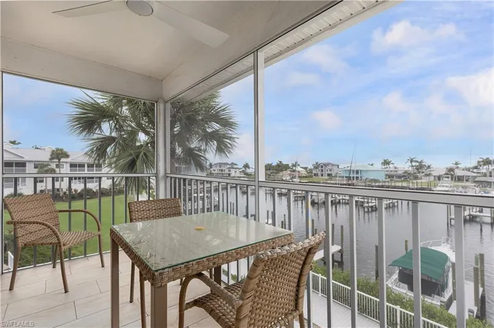 Balcony with a water view and a ceiling fan