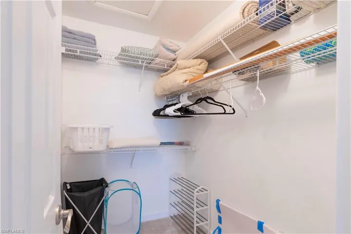 Walk in closet with light carpet