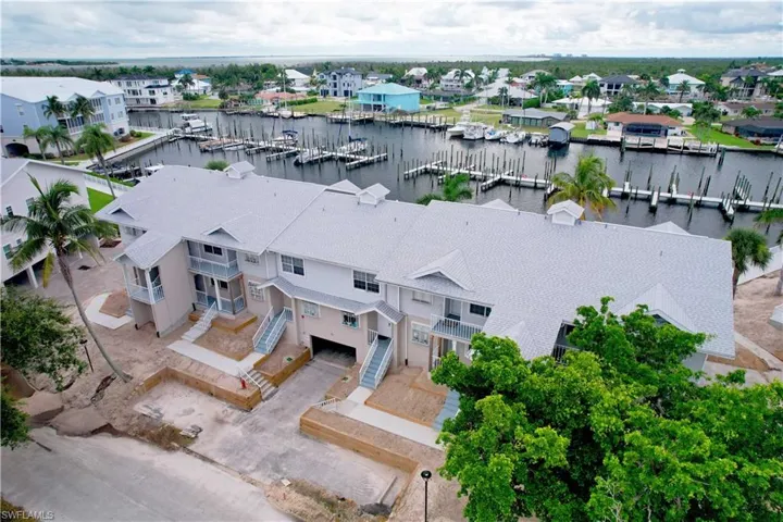 Aerial view of residential area with a nearby body of water and numerous boat docks
