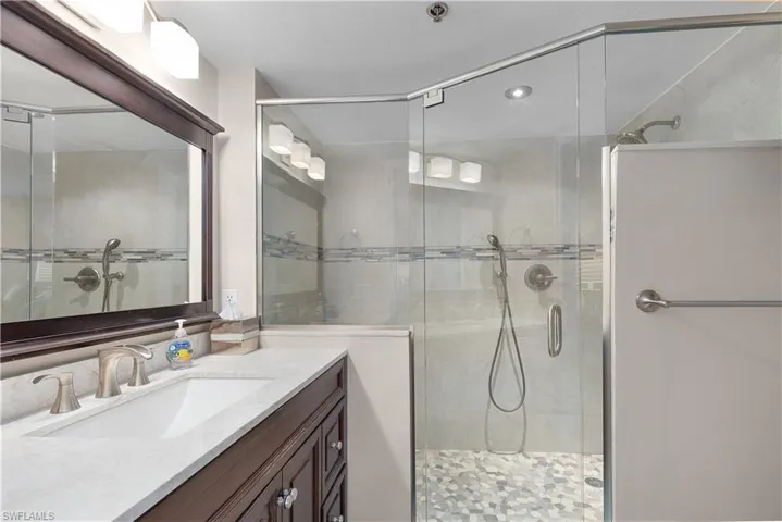 Bathroom featuring vanity and a shower stall