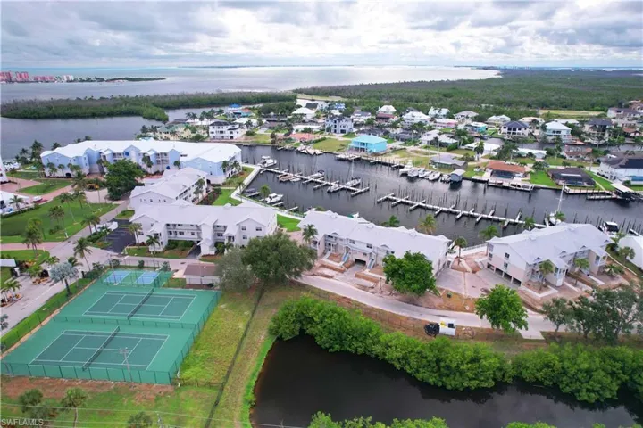 Aerial view of residential area with a large body of water and a marina