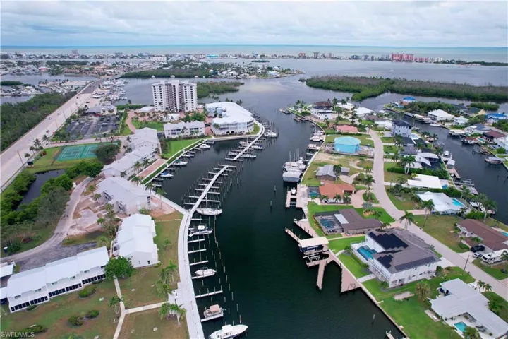 Aerial view of property and surrounding area with a nearby body of water
