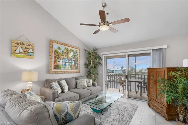 Living room featuring vaulted ceiling and ceiling fan