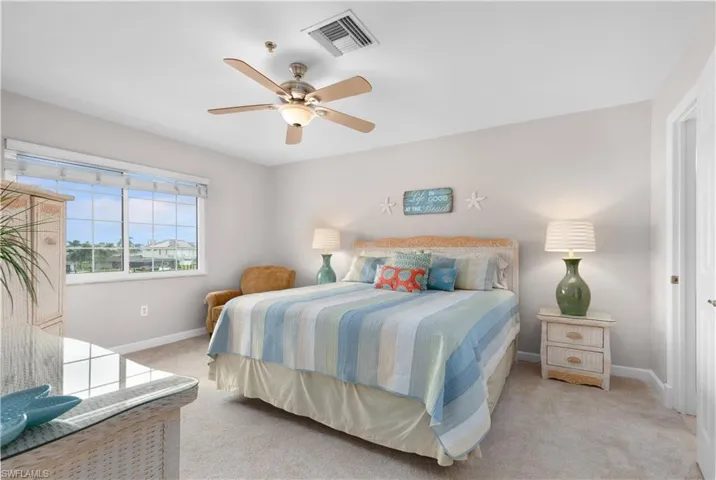 Bedroom featuring light colored carpet and a ceiling fan
