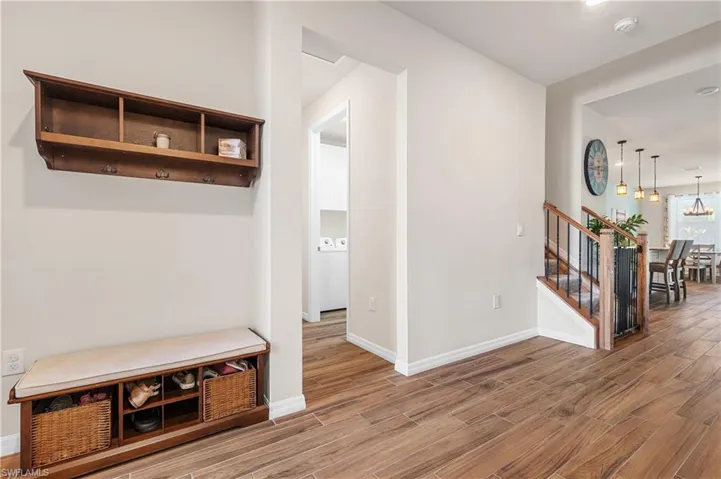 Mudroom with wood finished floors and washer / dryer
